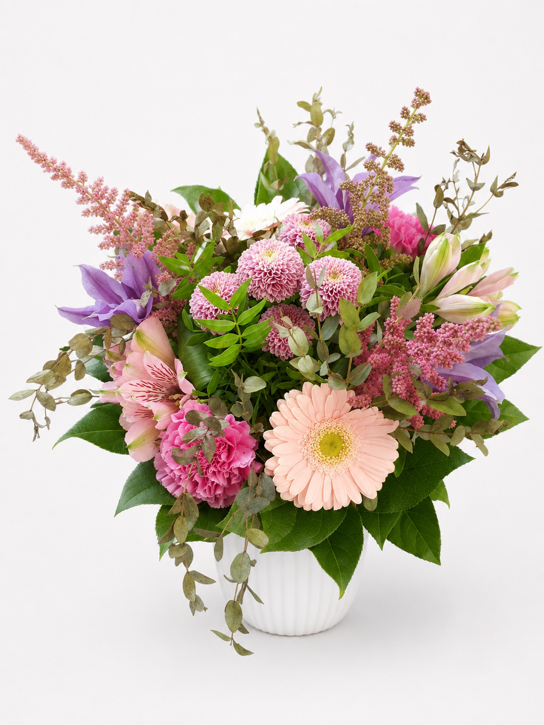 Farverig blomsterbuket i rosa, lilla og fersken nuancer